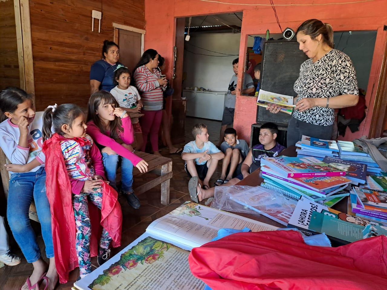 Raquel González lee a los niños que escuchan atentos