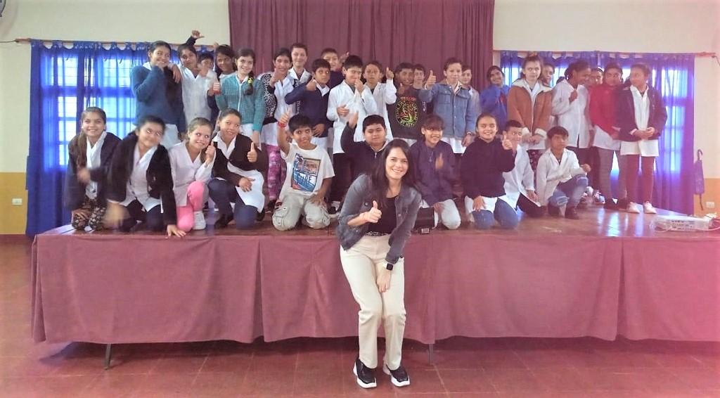 Integrante de Juego Responsable junto a los alumnos de la Escuela 638 de Apóstoles saludan sonrientes con el pulgar arriba.