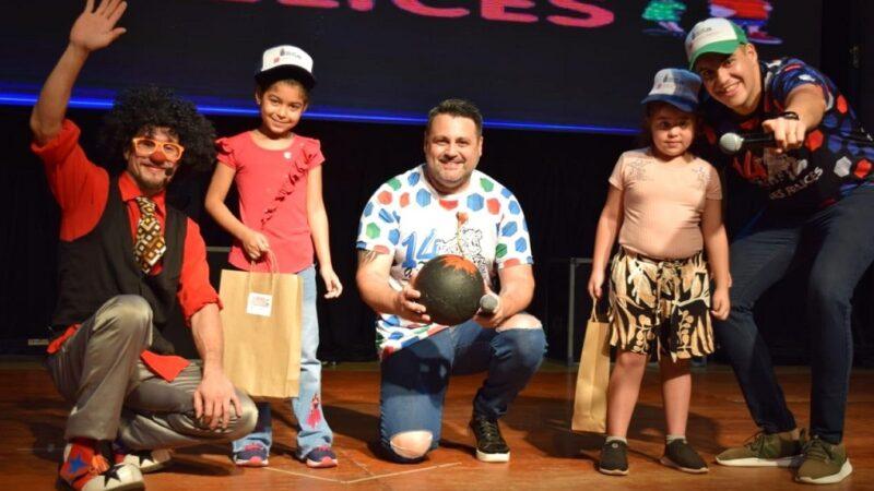 Dos niñas reciben sus obsequios de manos de Tata Pó y Marcelo Ledesma.