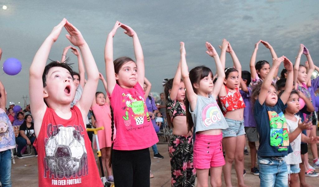 Niños alzan sus manos haciendo techo de casita.