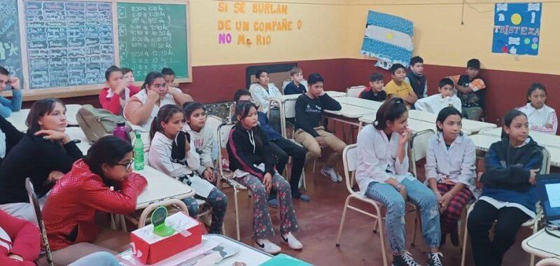 Alumnos de la escuela 86 miran video junto a sus docentes.