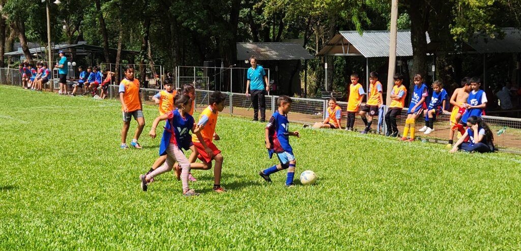 Niño lleva la pelota durante el partido.