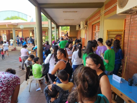 Vecinos esperan a ser atendidos en el patio de la escuela.