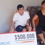 Cristian y su mamá muestran felices su cheque del premio de IPLyC Inclusivo.