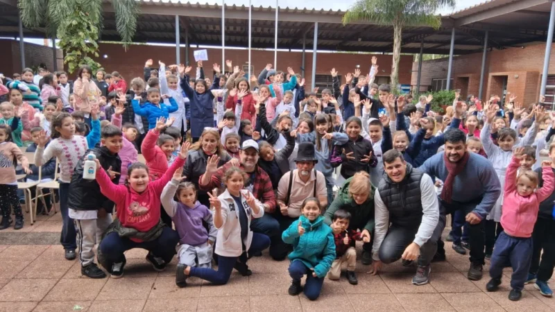 Equipo de Gurises Felices y multitud de niños de escuelas de Puerto Iguazú saludan felices a la cámara.