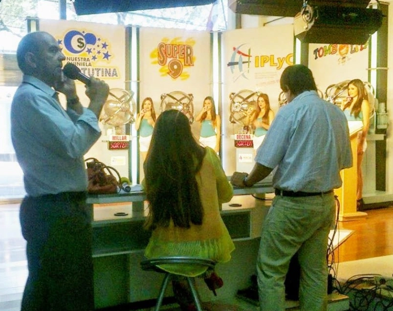 Ricardo Vera junto a escribana y operador en la sala de sorteos.