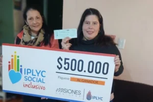 Bárbara y su mamá sonríen con su cheque. Con el dinero quiere cambiar su teléfono.