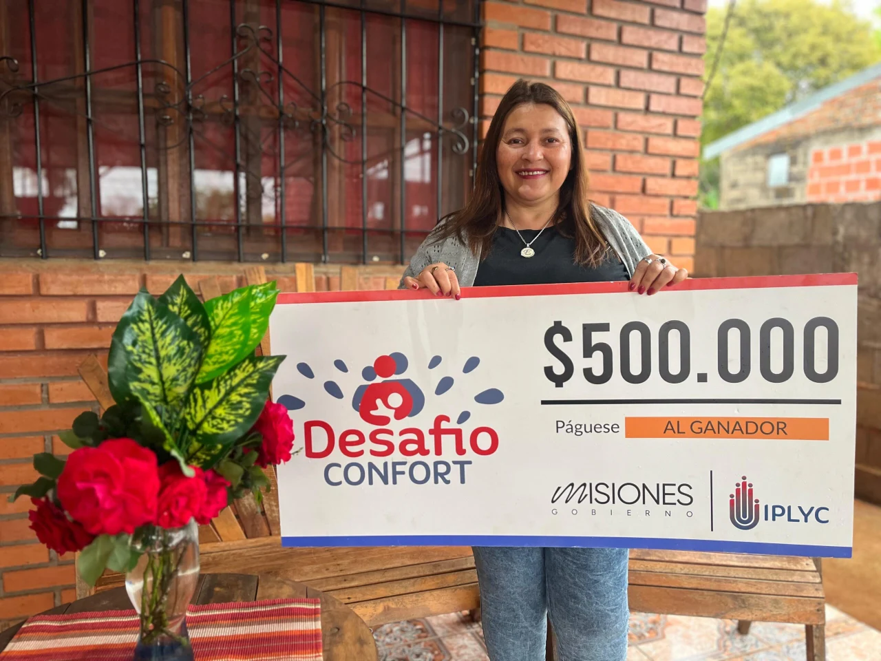 Estela, feliz con su cheque. Con el premio concluirá la construcción de su emprendimiento familiar.