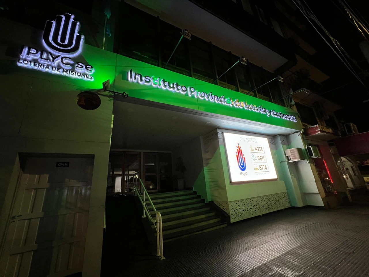 Fachada del IPLyC S.E. iluminada de verde por el Mes del Juego Responsable.