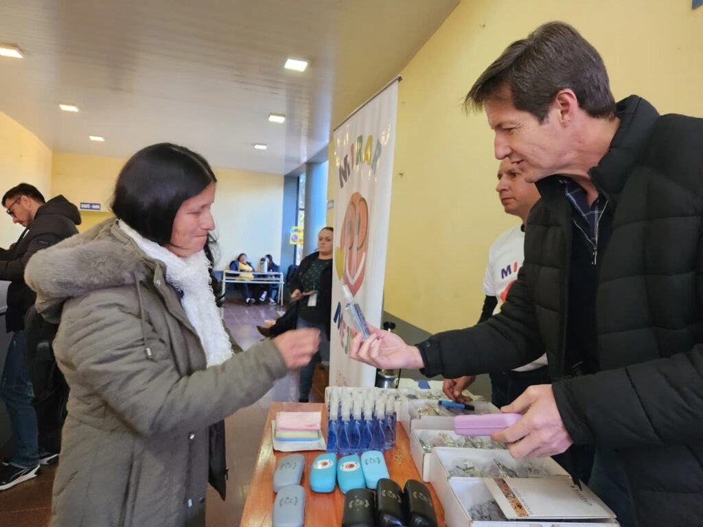 Héctor Decut entrega sus nuevos anteojos a una vecina de Campo Grande.
