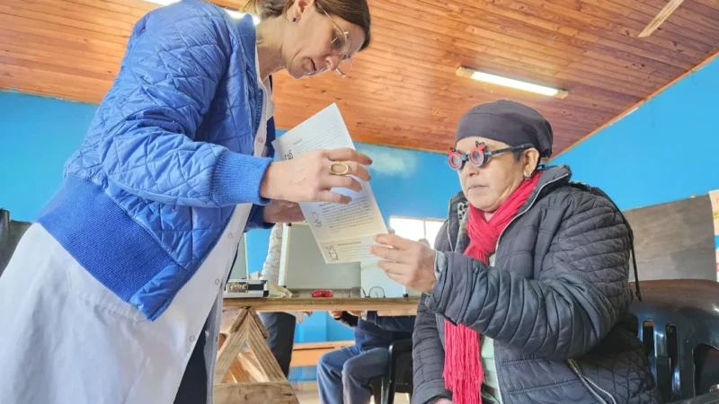 Vecina lee un texto con lentes graduados con ayuda de oftalmóloga de Mirar Mejor en Montecarlo.