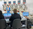 Bolilleros, locutora (de frente), escribanas y operador (de espaldas) en la sala de sorteos de la Quiniela Misionera.